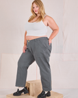 Angled front view of Mid-Rise Work Pants in Slate Grey and Cropped Tank in vintage tee off-white on Juliet