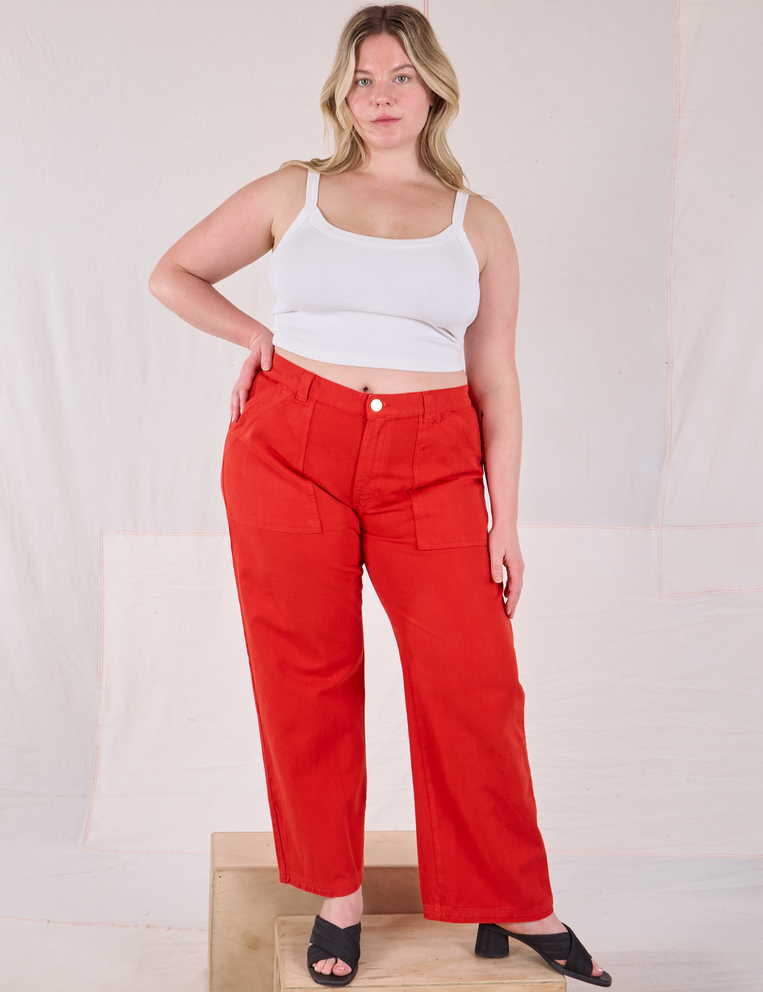 Lish is 5’8” and wearing XL Mid-Rise Work Pants in Mustang Red paired with a Cropped Cami in Vintage Tee Off-White