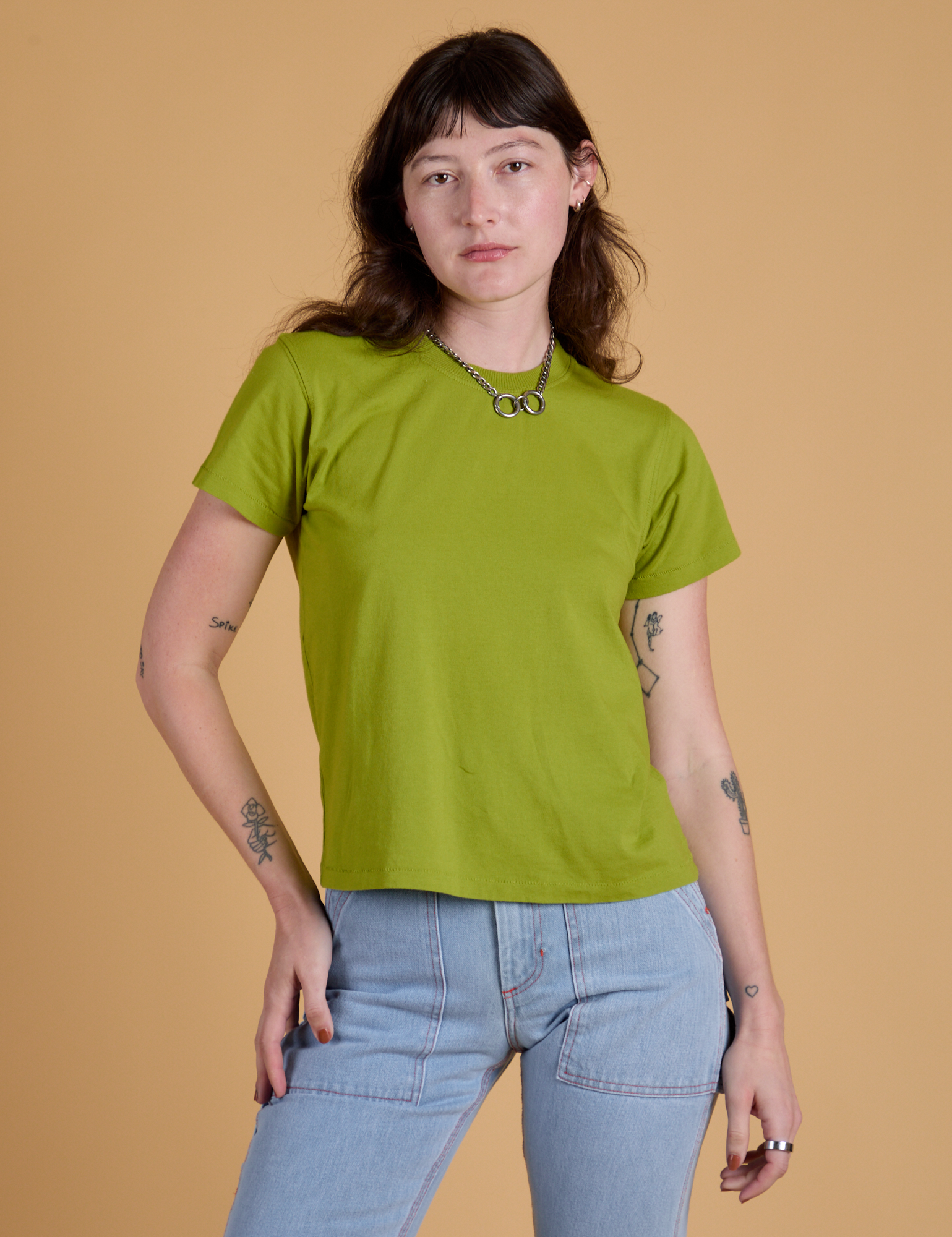 Alex is 5’8” and wearing P Organic Vintage Tee in Gross Green
