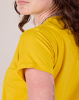 Organic Vintage Tee in Golden Yellow shoulder close up on Alex