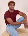 Issac is wearing Organic Vintage Tee in Red Wine and light wash Carpenter Jeans