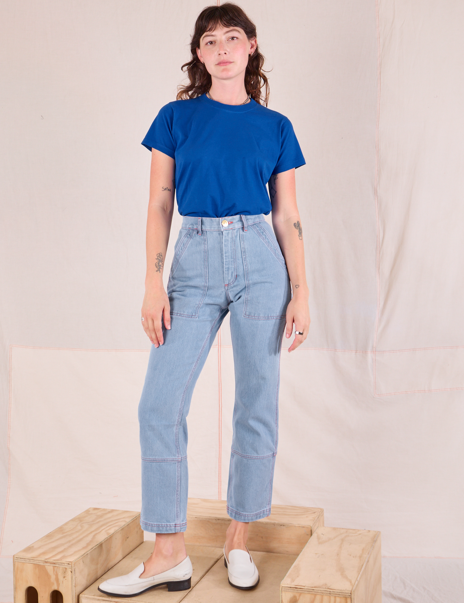 Alex is wearing Organic Vintage Tee in Royal Blue tucked into light wash Carpenter Jeans