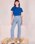 Alex is wearing Organic Vintage Tee in Royal Blue tucked into light wash Carpenter Jeans