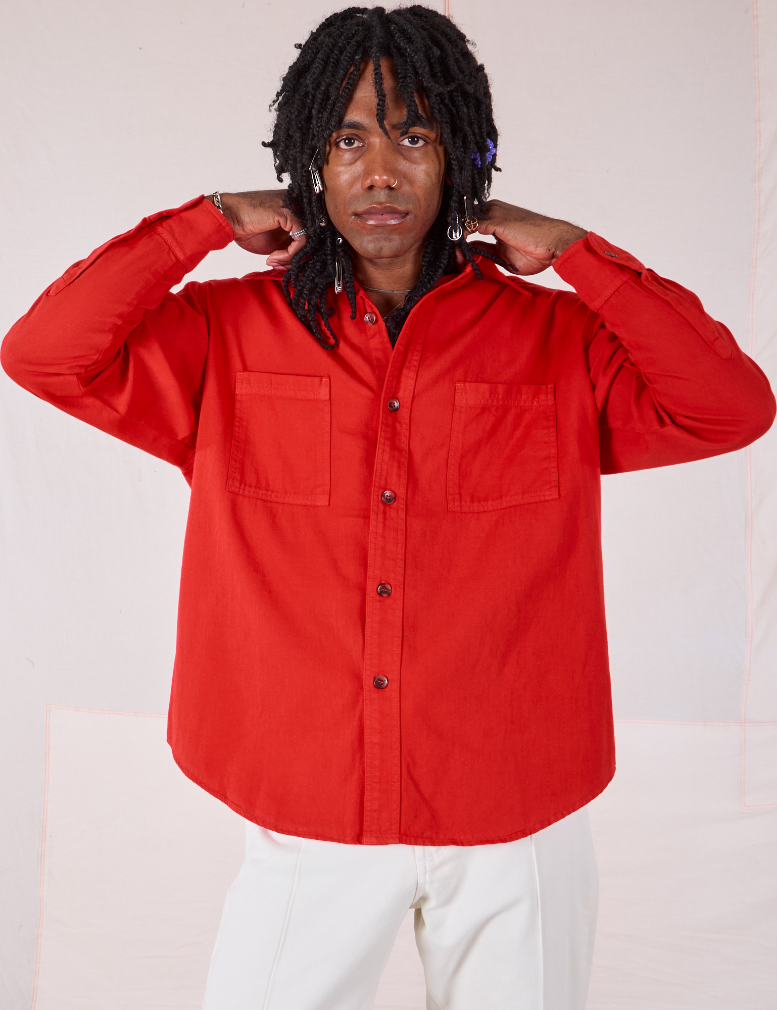 Jerrod is wearing a buttoned up Twill Overshirt in Mustang Red