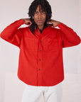 Jerrod is wearing a buttoned up Twill Overshirt in Mustang Red