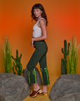 Side view of Paintstamped Work Pants in Cactus and Cropped Tank in Vintage Tee White on Alex