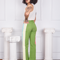 Angled view of Hand-Painted Stripe Western Pants in Bright Olive and vintage off-white Tank Top worn by Jesse