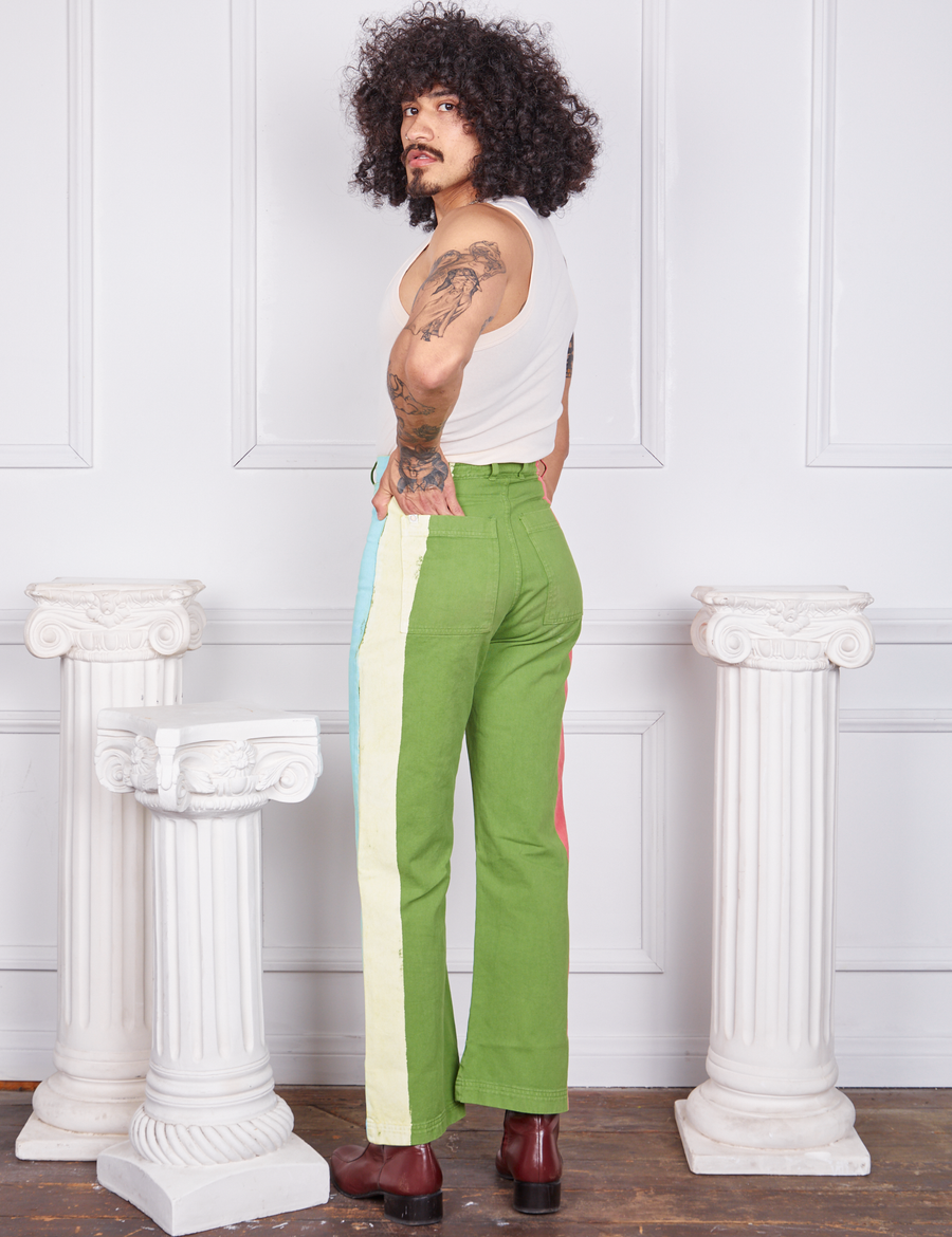 Angled view of Hand-Painted Stripe Western Pants in Bright Olive and vintage off-white Tank Top worn by Jesse