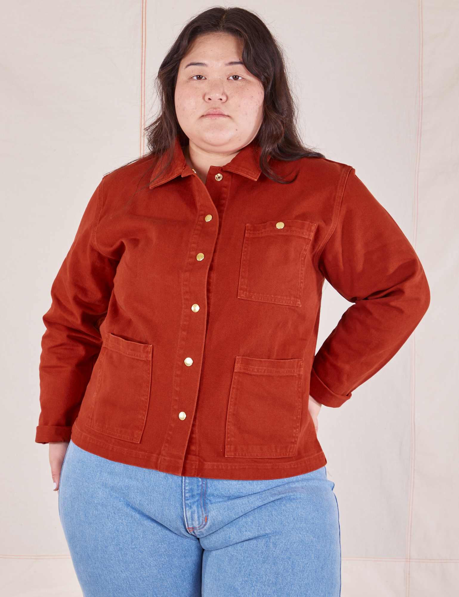 Ashley is wearing a buttoned up Denim Work Jacket in Paprika