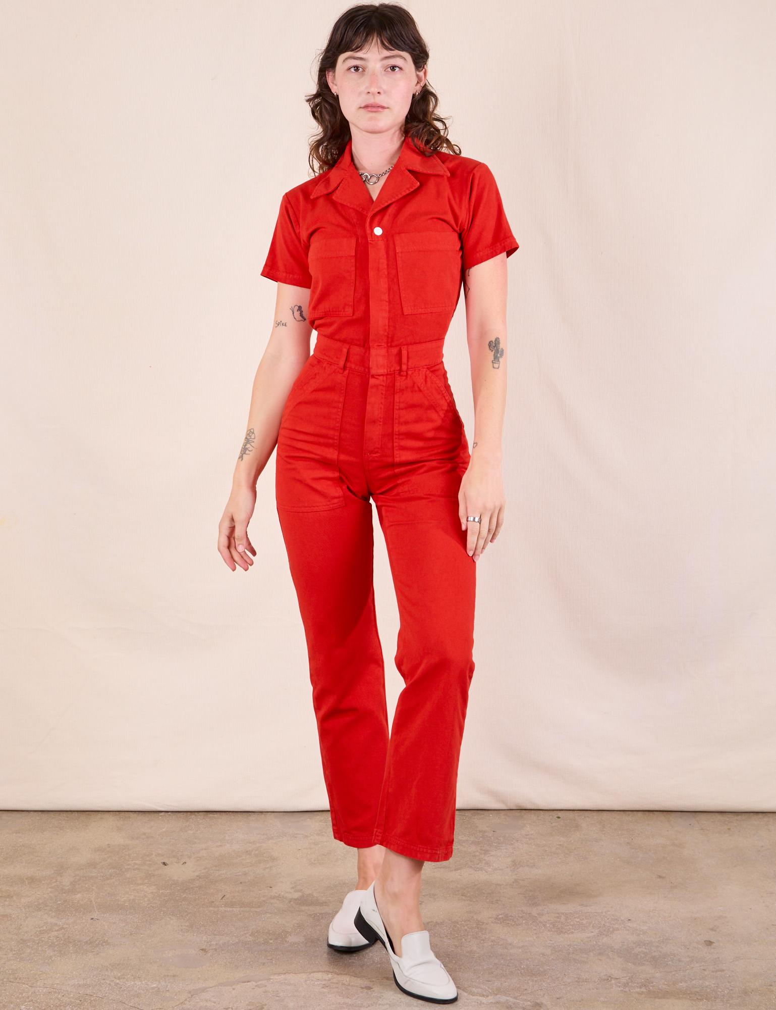 Alex is wearing Short Sleeve Jumpsuit in Mustang Red