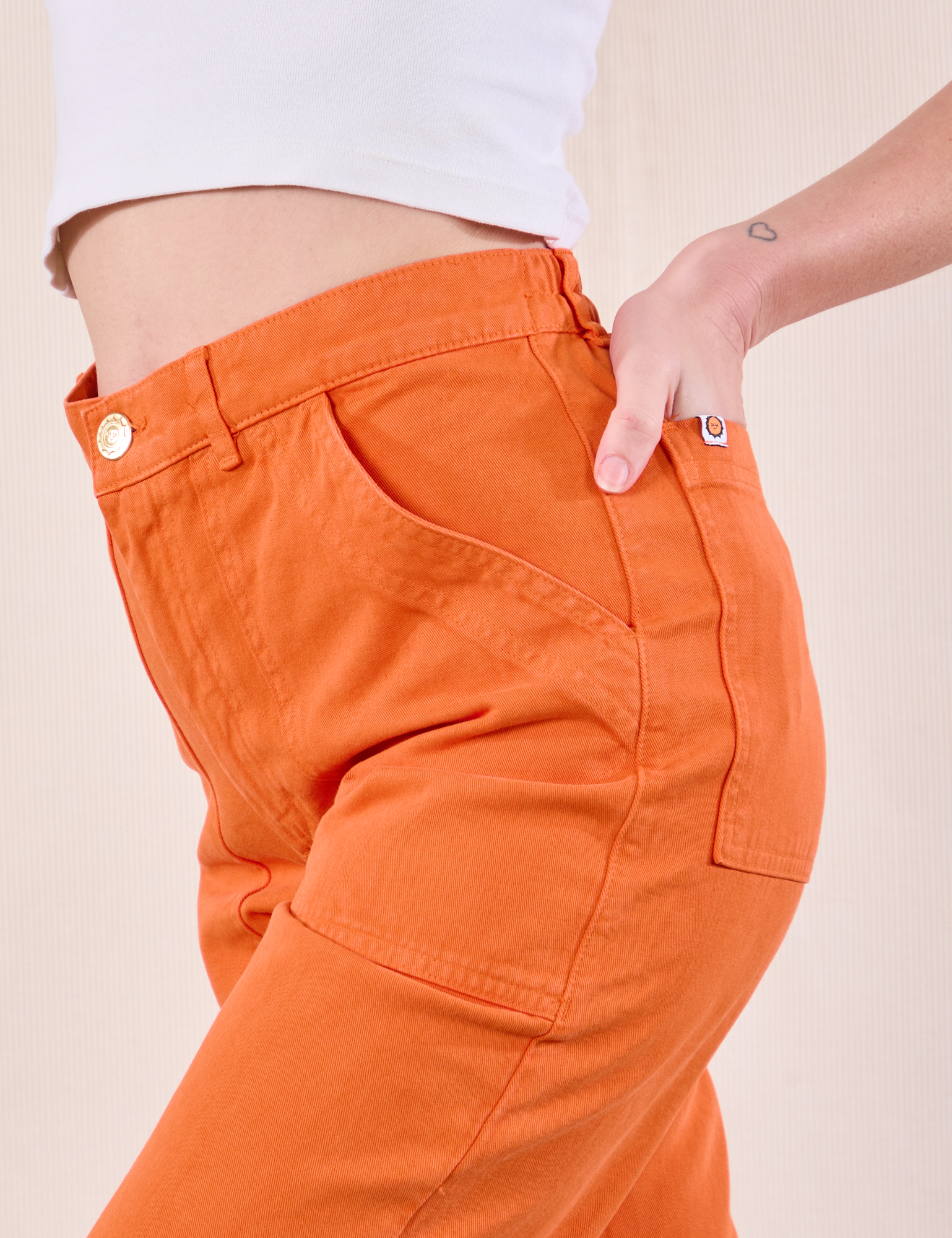 Work Pants in Construction Orange close up side view on Alex