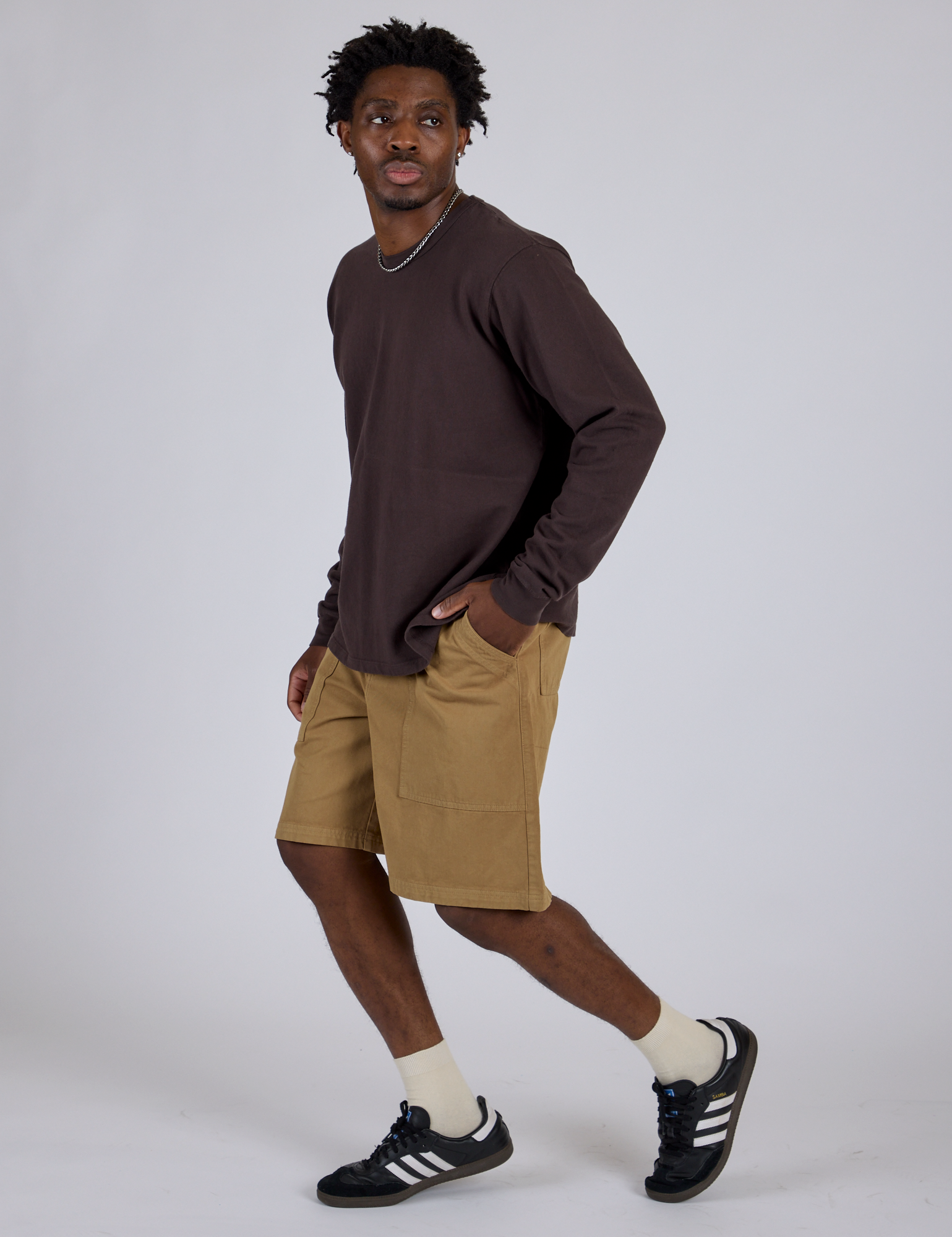 Side view of Longline Work Shorts in Desert Brown and espresso brown Long Sleeve Burly Tee on Isaac