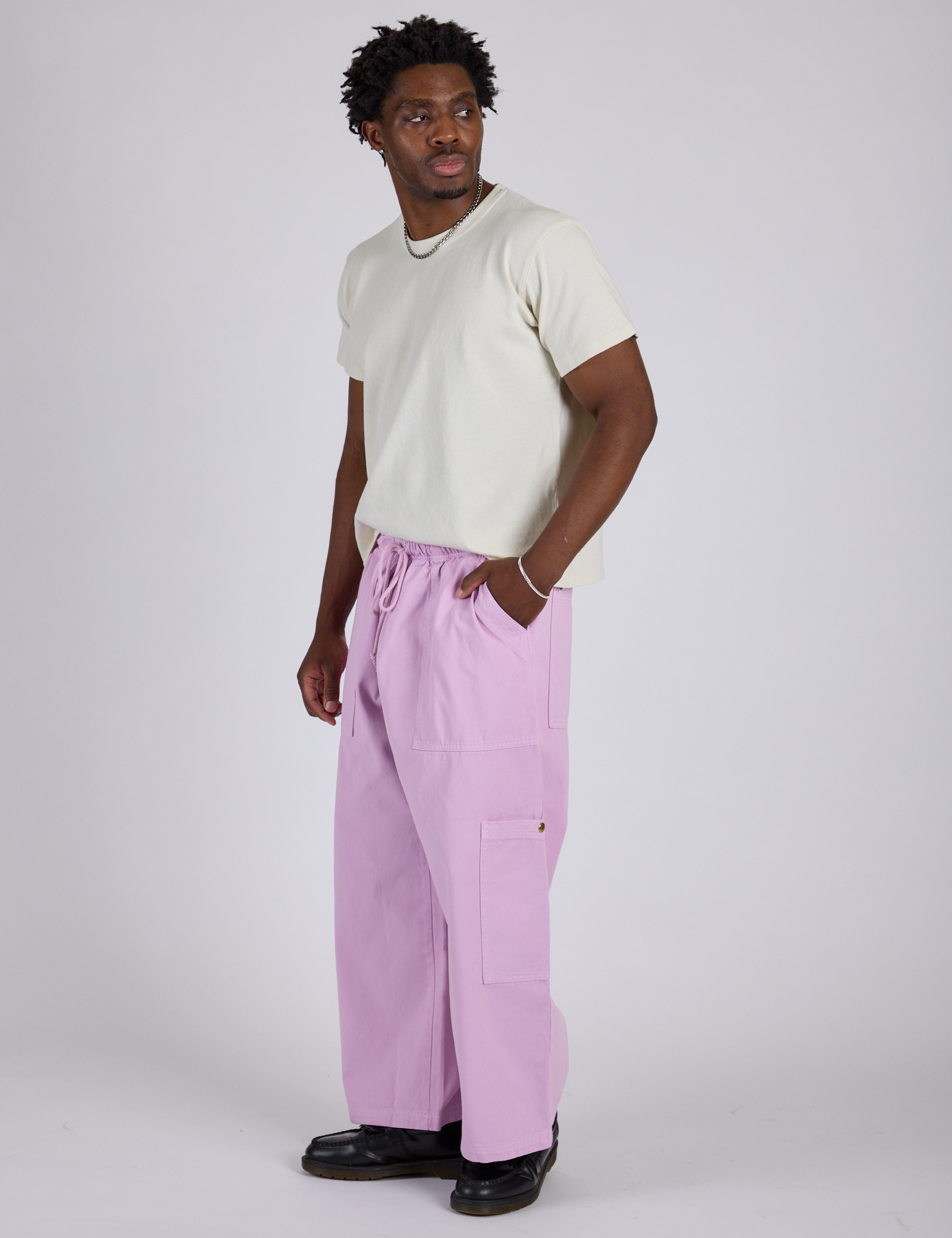 Side view of Drop Pocket Cargo Pants in Lilac Purple and Organic Vintage Tee in Vintage Tee White on Isaac