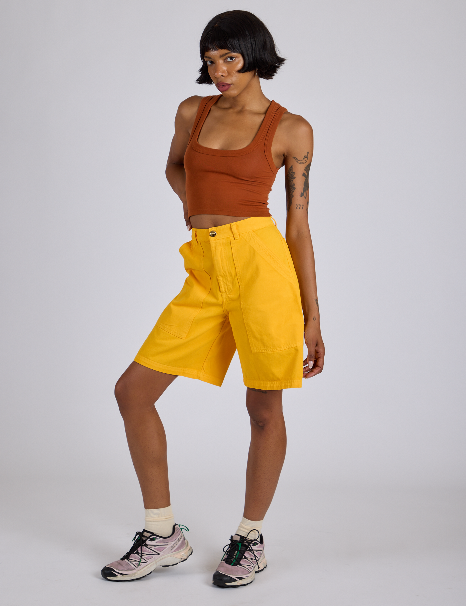 Angled front view of Longline Work Shorts in Sunshine Yellow and burnt terracotta Cropped Tank