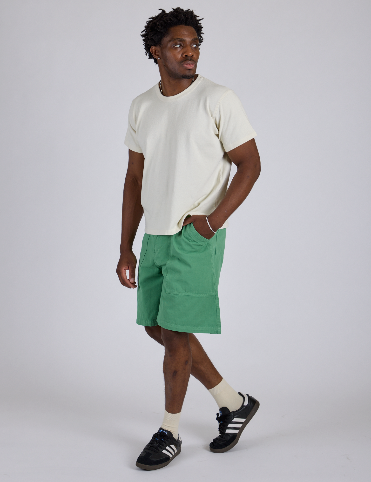 Angled view of Longline Work Shorts in Seafoam Green and Burly Tee in Vintage Tee White