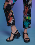 Short Sleeve Jumpsuit in Rainbow Magic Waters pant leg close up on Alex