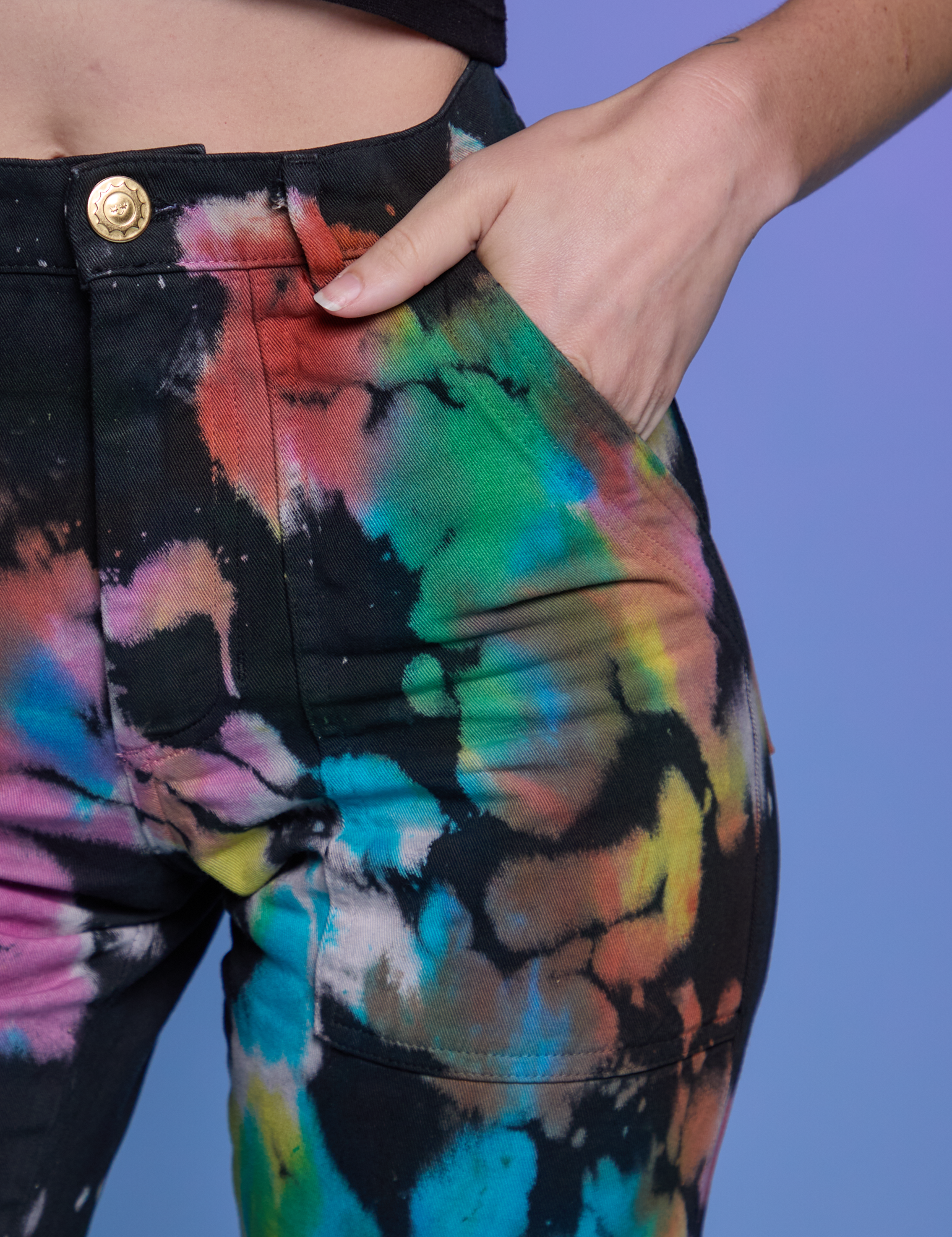 Close up of Alex&#39;s hand in the front pocket of Work Pants in Rainbow Magic Waters