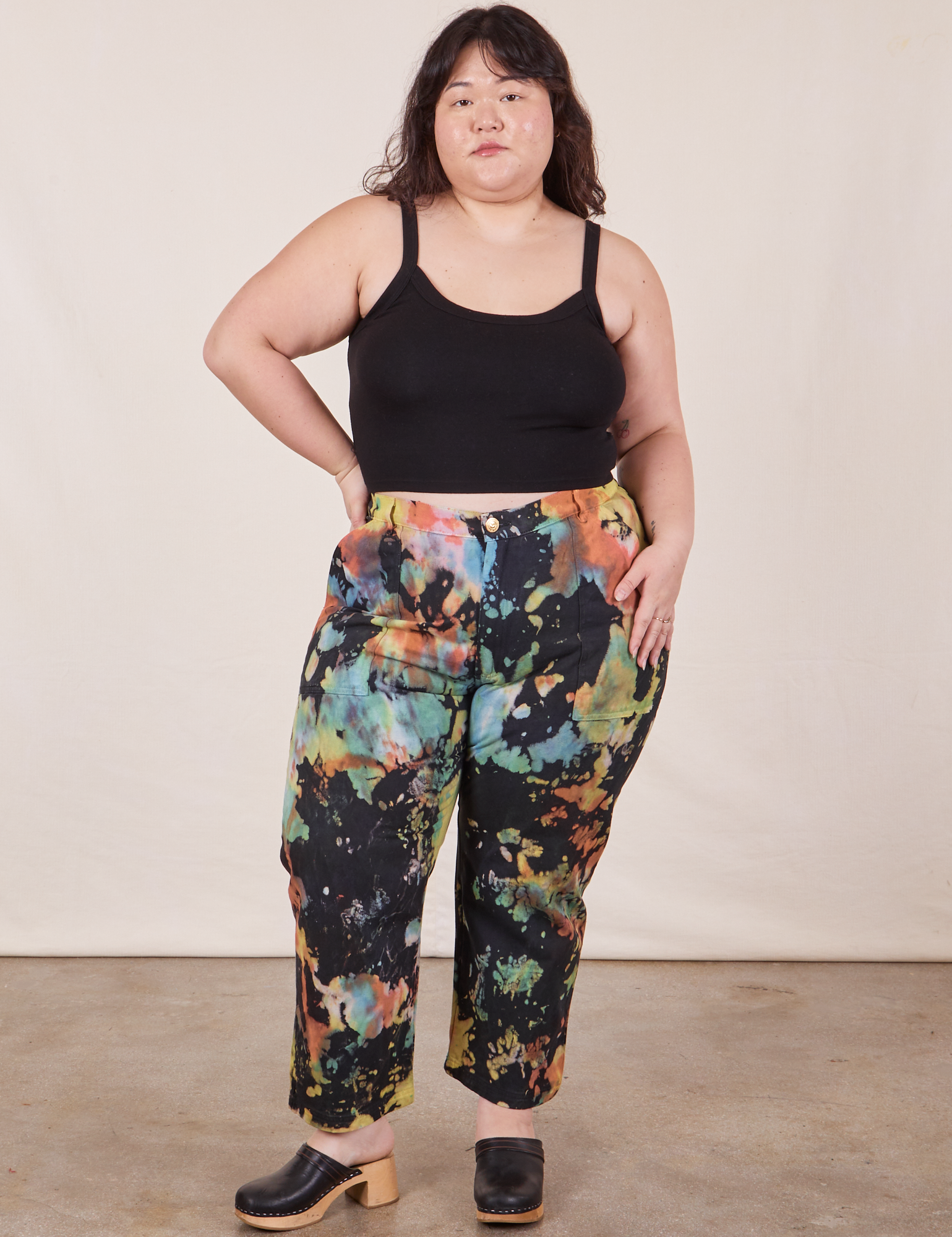 Ashley is 5&#39;7&quot; and wearing 1XL Petite Rainbow Magic Waters Work Pants paired with black Cropped Cami
