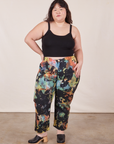 Ashley is 5'7" and wearing 1XL Petite Rainbow Magic Waters Work Pants paired with black Cropped Cami