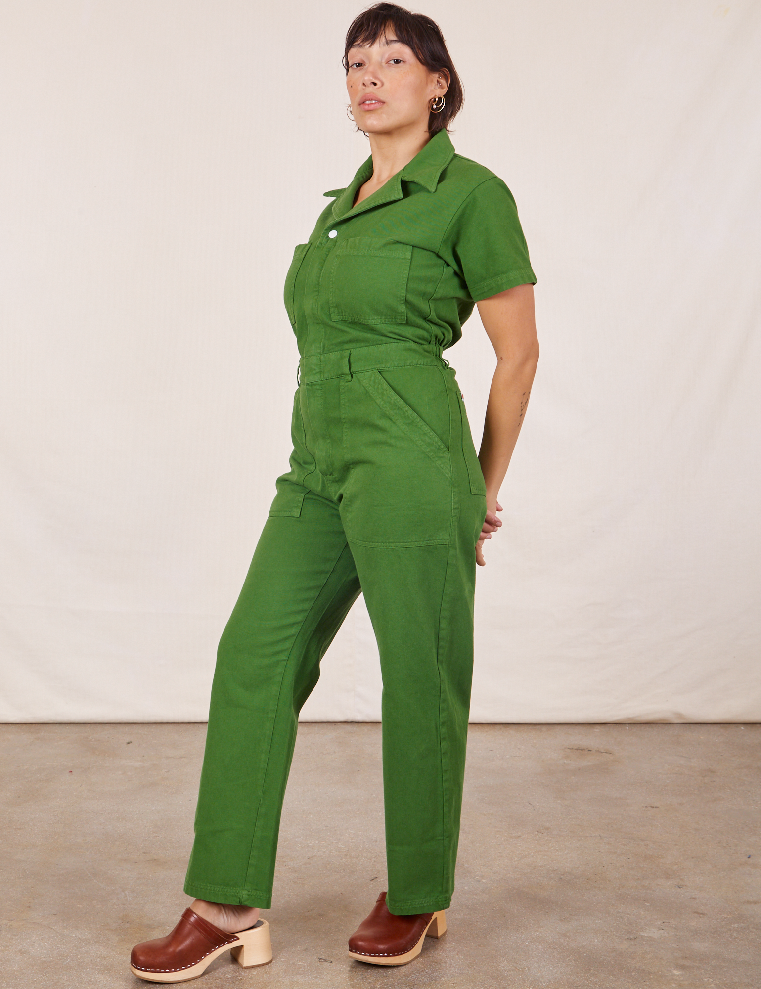Angled view of Short Sleeve Jumpsuit in Lawn Green worn by Tiara