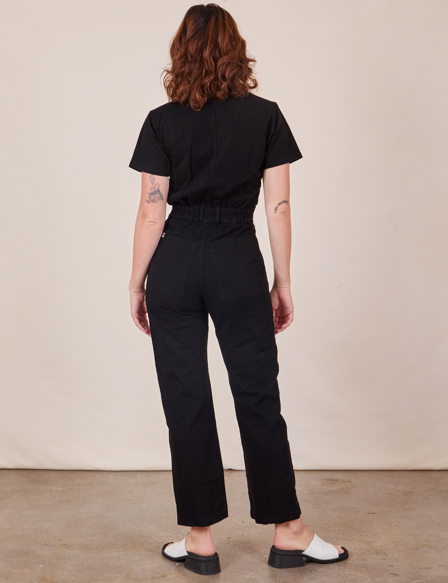 Back view of Short Sleeve Jumpsuit in Basic Black worn by Alex