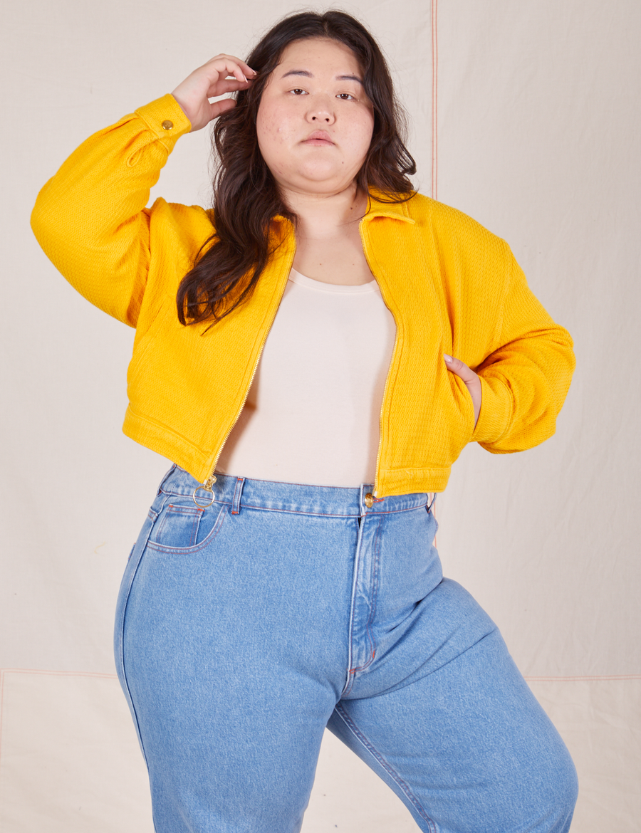 Ashley is 5'7" and wearing L Ricky Jacket in Sunshine Yellow paired with a vintage off-white Tank Top underneath