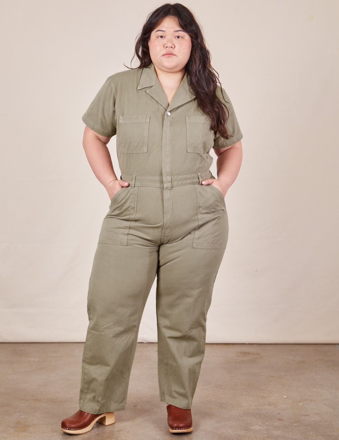 Ashley is 5'7" and wearing 1XL Short Sleeve Jumpsuit in Khaki Grey
