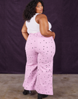 Angled back view of Star Bell Bottoms in Lilac Purple and Cropped Tank in vintage tee off-white on Morgan