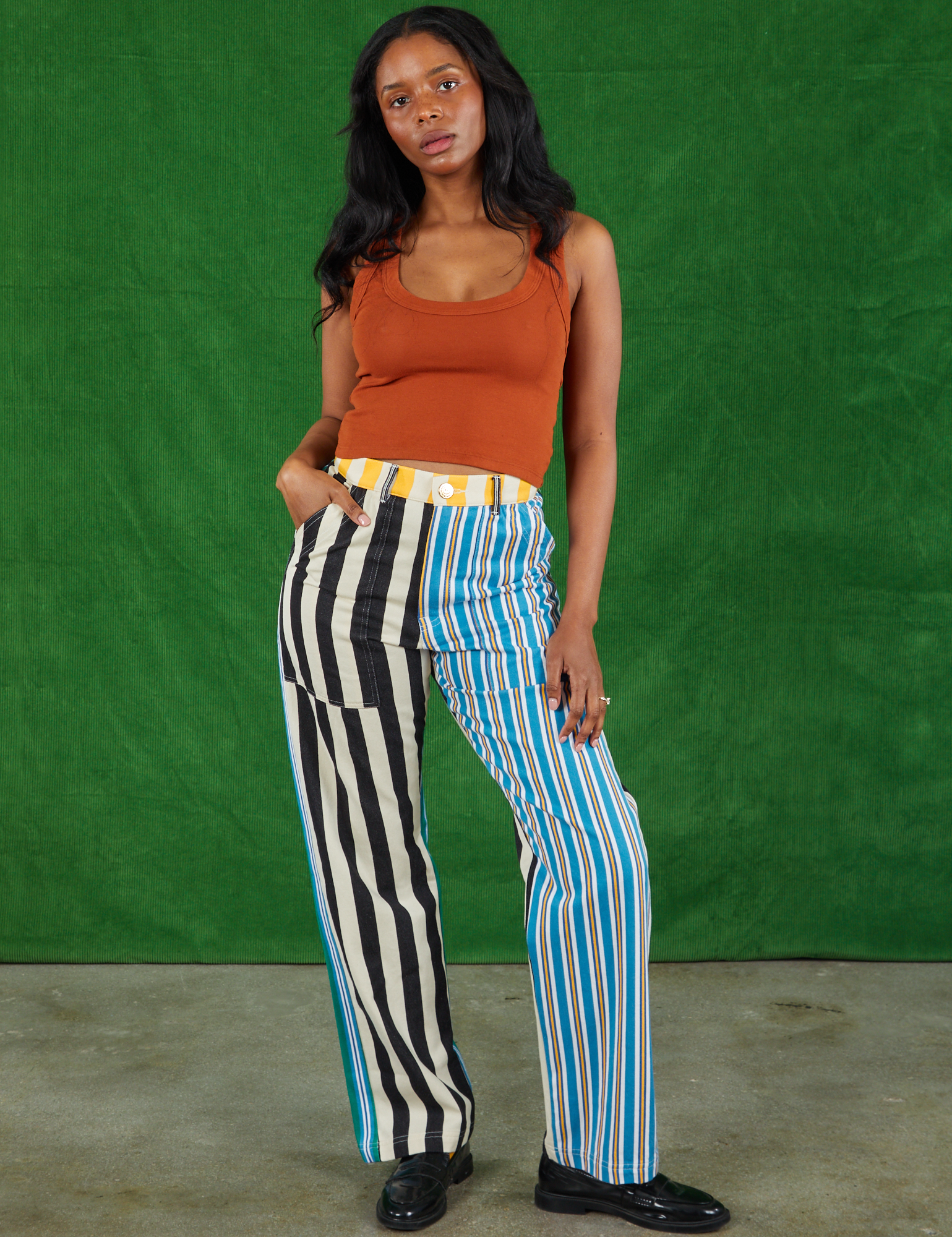 Kandia is 5&#39;3&quot; and wearing S Mismatched Stripe Work Pants paired with a burnt terracotta Cropped Tank Top