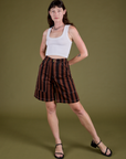 Alex is 5’8” and wearing XXS Longline Work Shorts in Fudgesicle Brown paired with a vintage tee white Cropped Tank