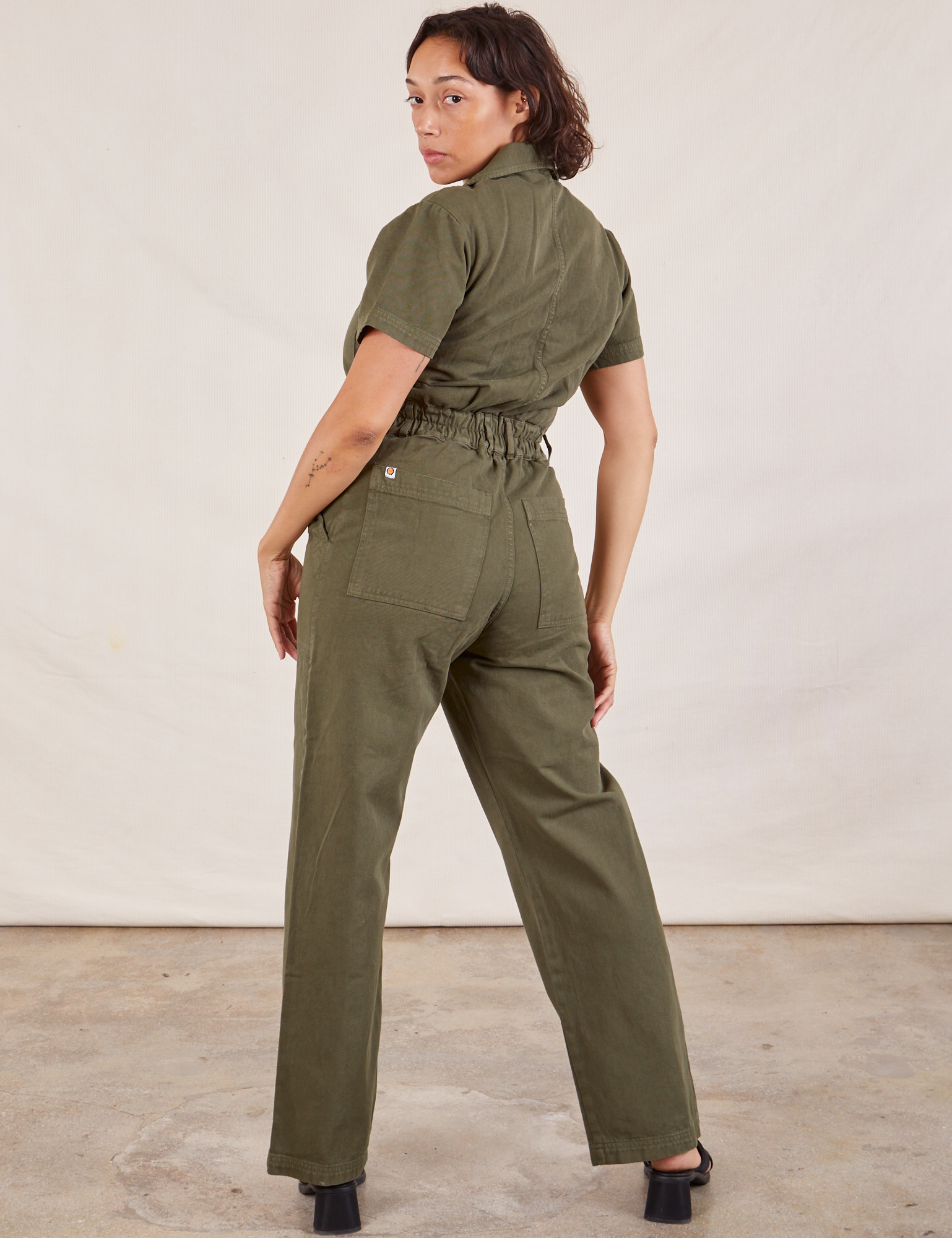 Short Sleeve Jumpsuit in Surplus Green back view on Tiara