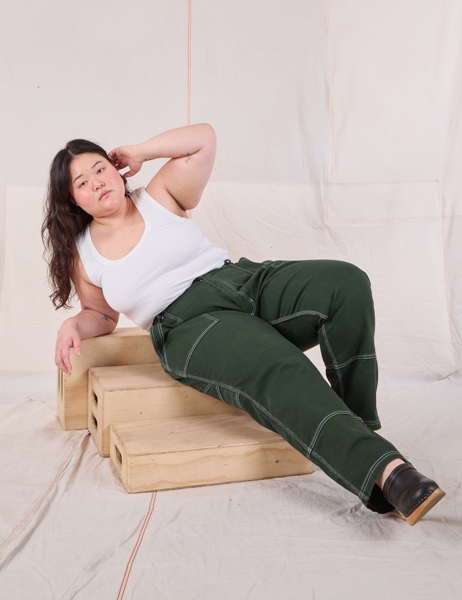 Ashley is wearing Carpenter Jeans in Swamp Green