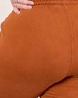 Cropped Rolled Cuff Sweatpants in Burnt Terracotta back close up on Ashley