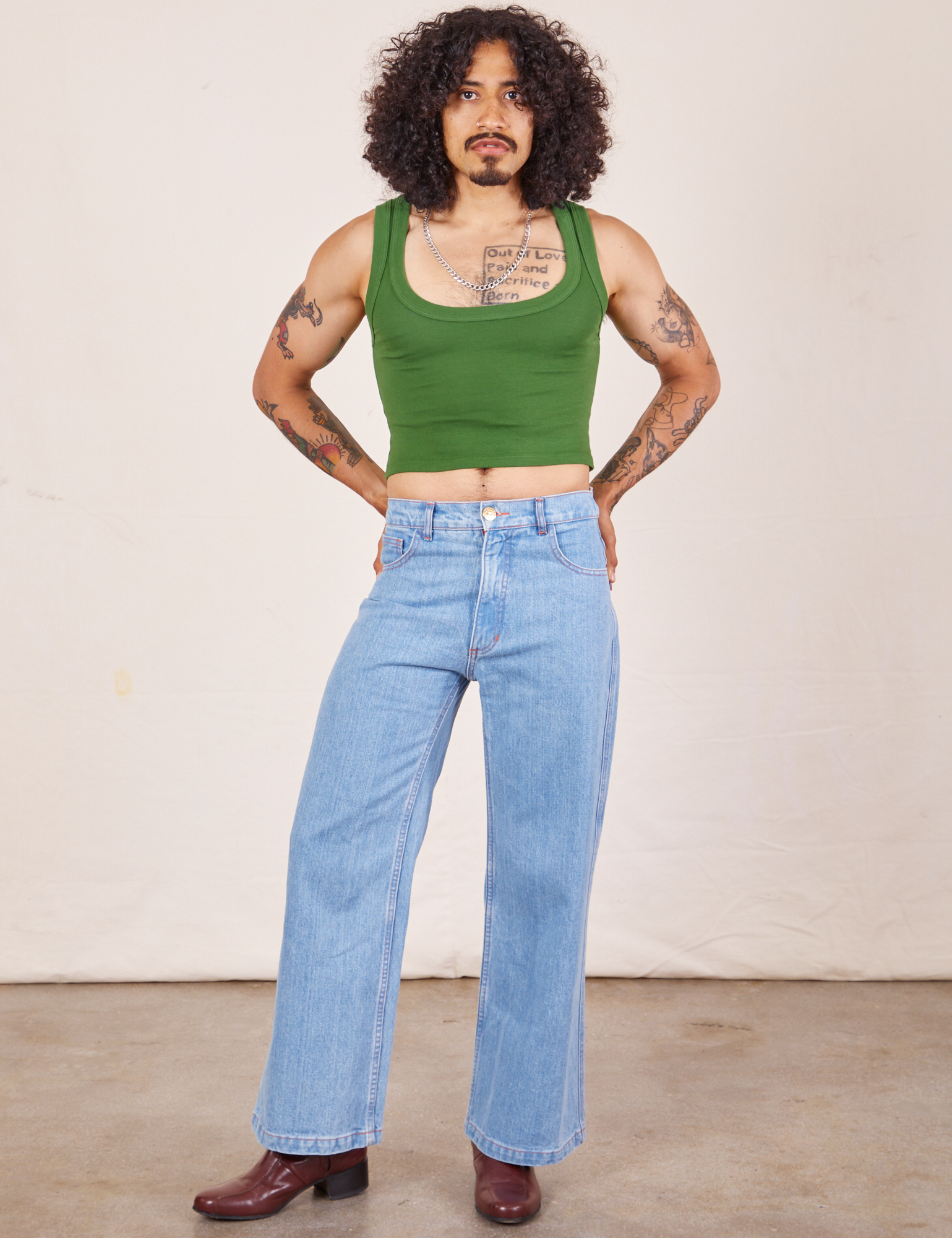Jesse is wearing Cropped Tank Top in Lawn Green and light wash Sailor Jeans