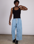 Isaac is wearing The Tank Top in Basic Black paired with light wash denim drop pocket pants