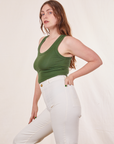 Side view of Tank Top in Dark Emerald Green and vintage off-white Western Pants on Allison