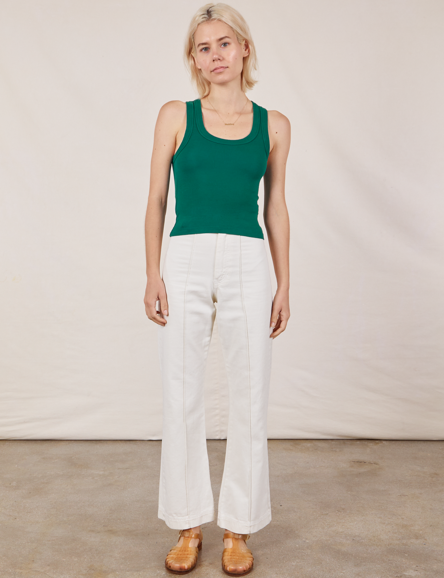 Madeline is wearing Tank Top in Hunter Green and vintage tee off-white Western Pants