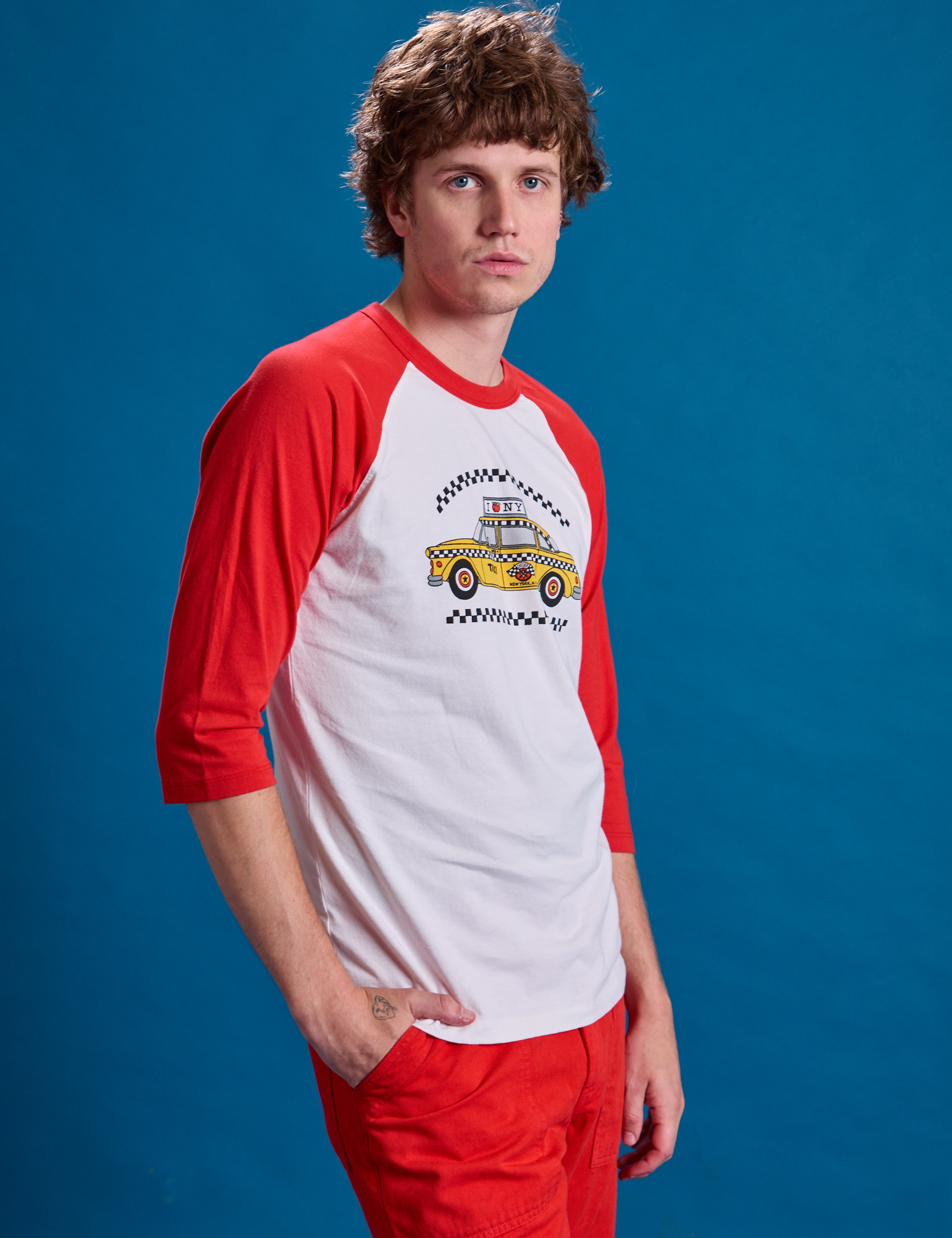 Taxi Raglan Tee in NYC side view on Quinn