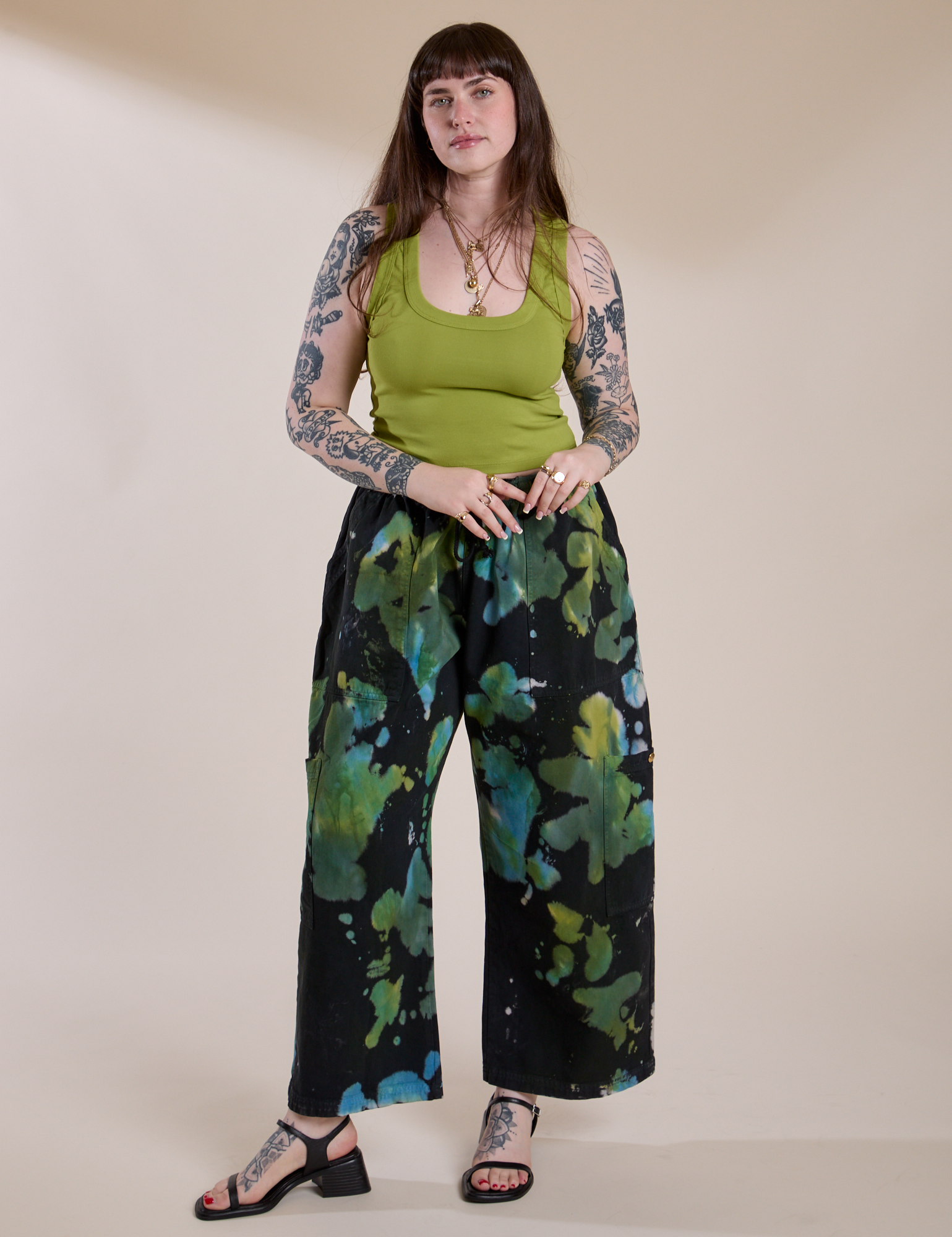Sydney is 5'9" and wearing L for an oversized look Magic Waters Drop Pocket Pants in Green Pool paired with a gross green Cropped Tank