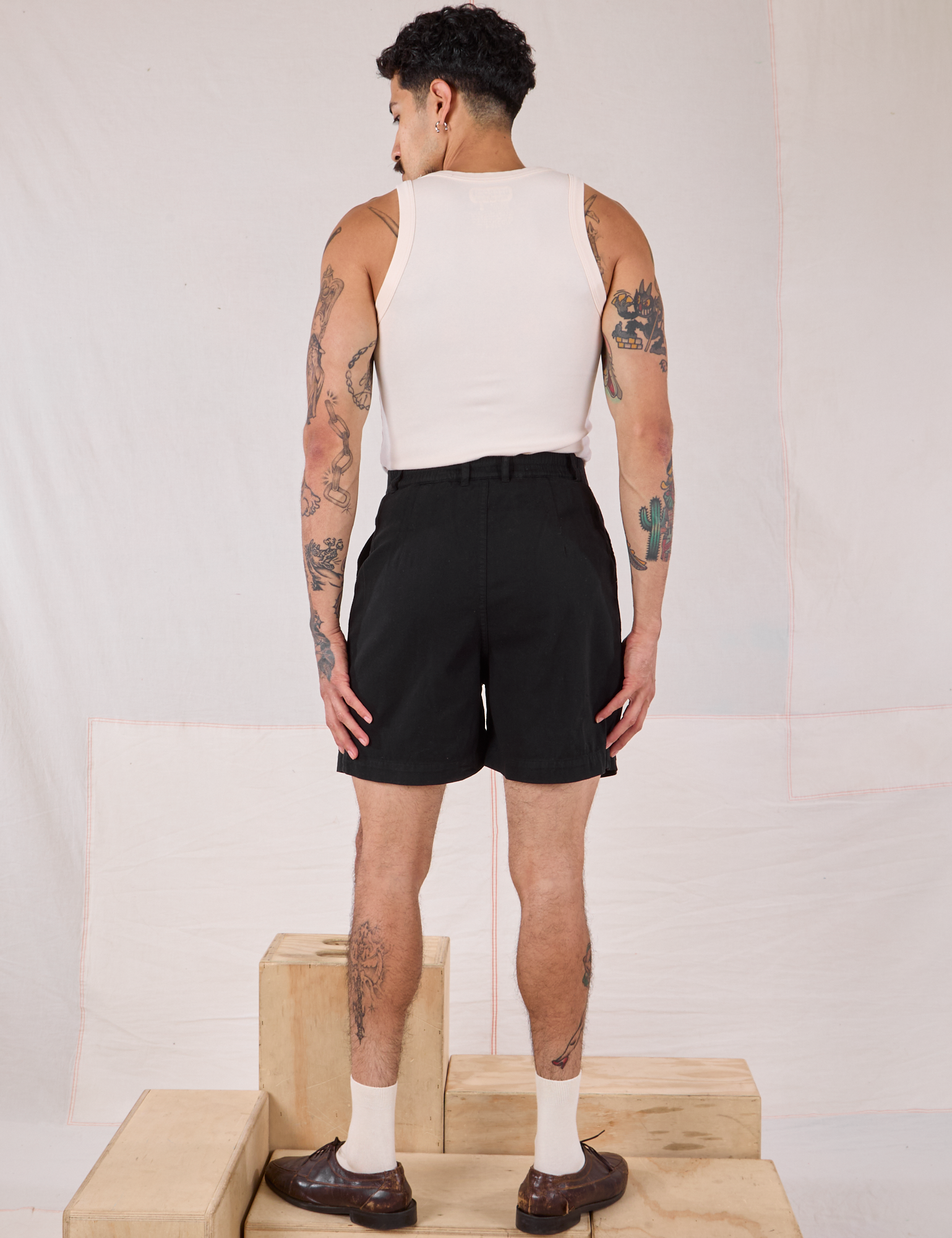 Back view of Trouser Shorts in Basic Black and Tank Top in Vintage Tee Off-White on Jesse