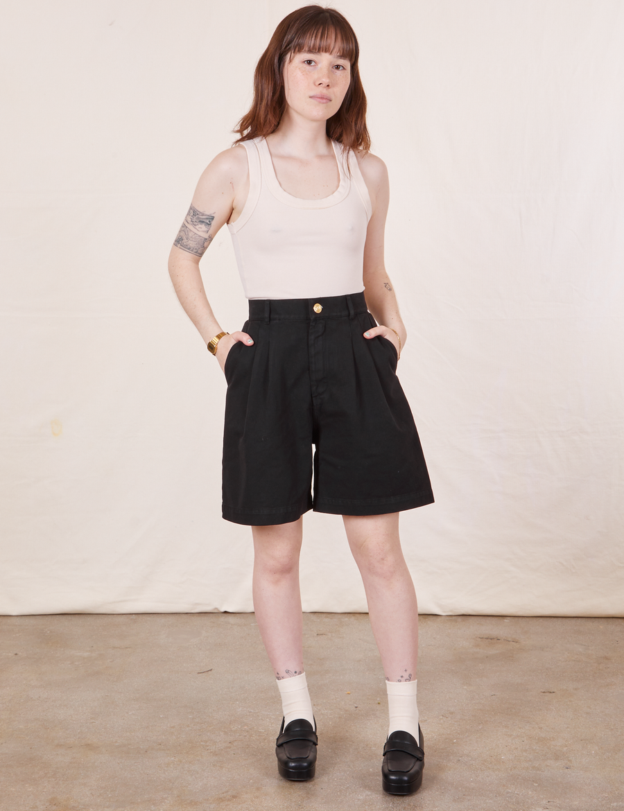 Hana is 5'3" and wearing XXS Trouser Shorts in Basic Black paired with a vintage off-white Tank Top