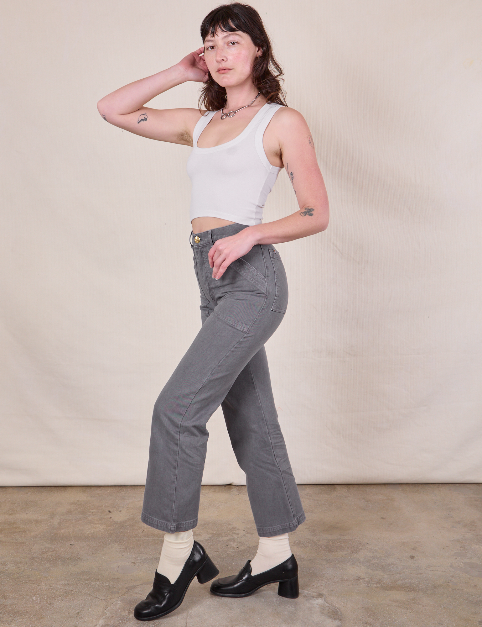 Side view of Work Pants in Washed Grey and Cropped Tank in Vintage Tee Off-White on Alex