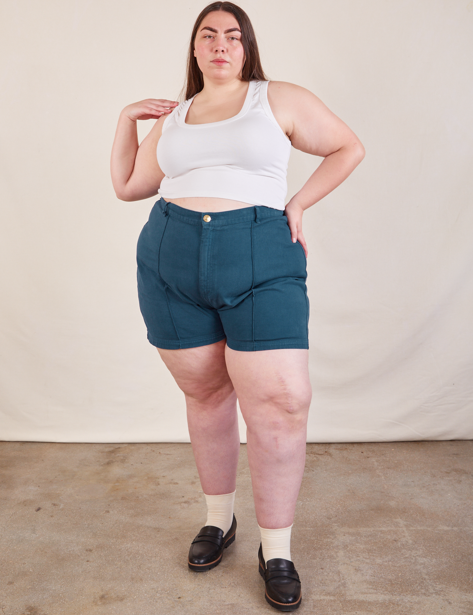 Marielena is 5&#39;8&quot; and wearing 2XL Western Shorts in Lagoon paired with Cropped Tank in vintage tee off-white