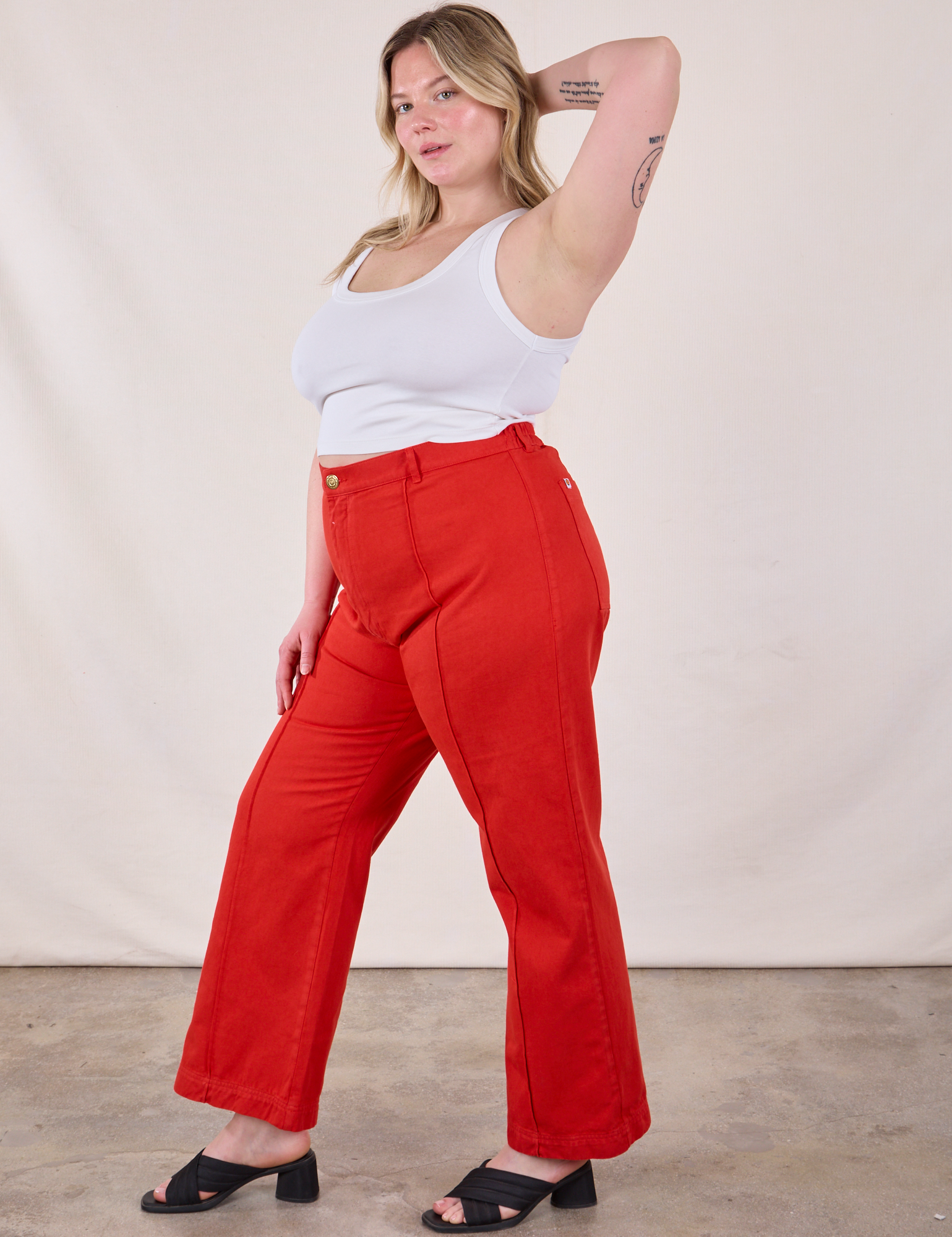 Side view of Western Pants in Mustang Red and Cropped Cami in Vintage Tee Off-White on Lish