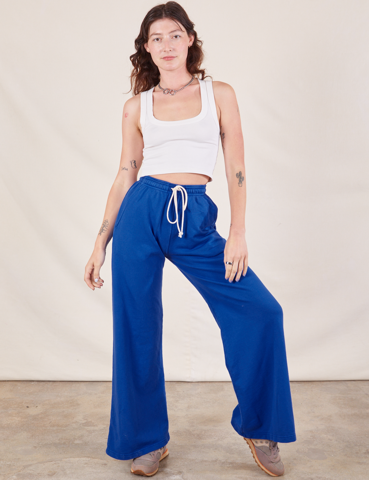 Alex is 5&#39;8&quot; and wearing P Wide Leg Sweat Pants in Royal Blue paired with Cropped Tank in vintage tee off-white