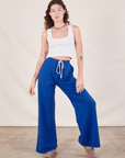 Alex is 5'8" and wearing P Wide Leg Sweat Pants in Royal Blue paired with Cropped Tank in vintage tee off-white