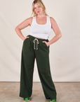 Lish is 5'8" and wearing M Wide Leg Sweat Pants in Swamp Green paired with Cropped Tank in vintage tee off-white