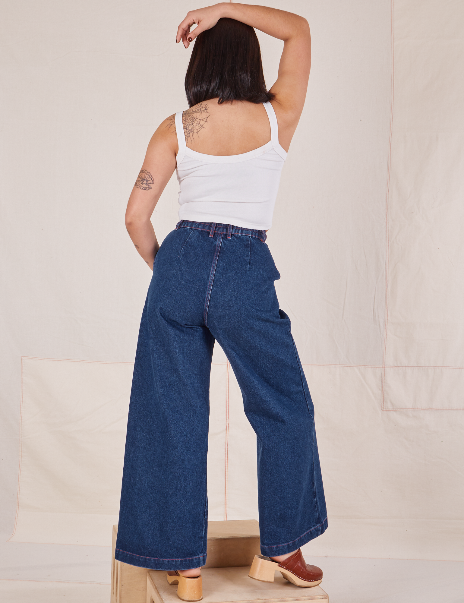 Back view of Indigo Wide Leg Trousers in Dark Wash and vintage off-white Cami on Betty