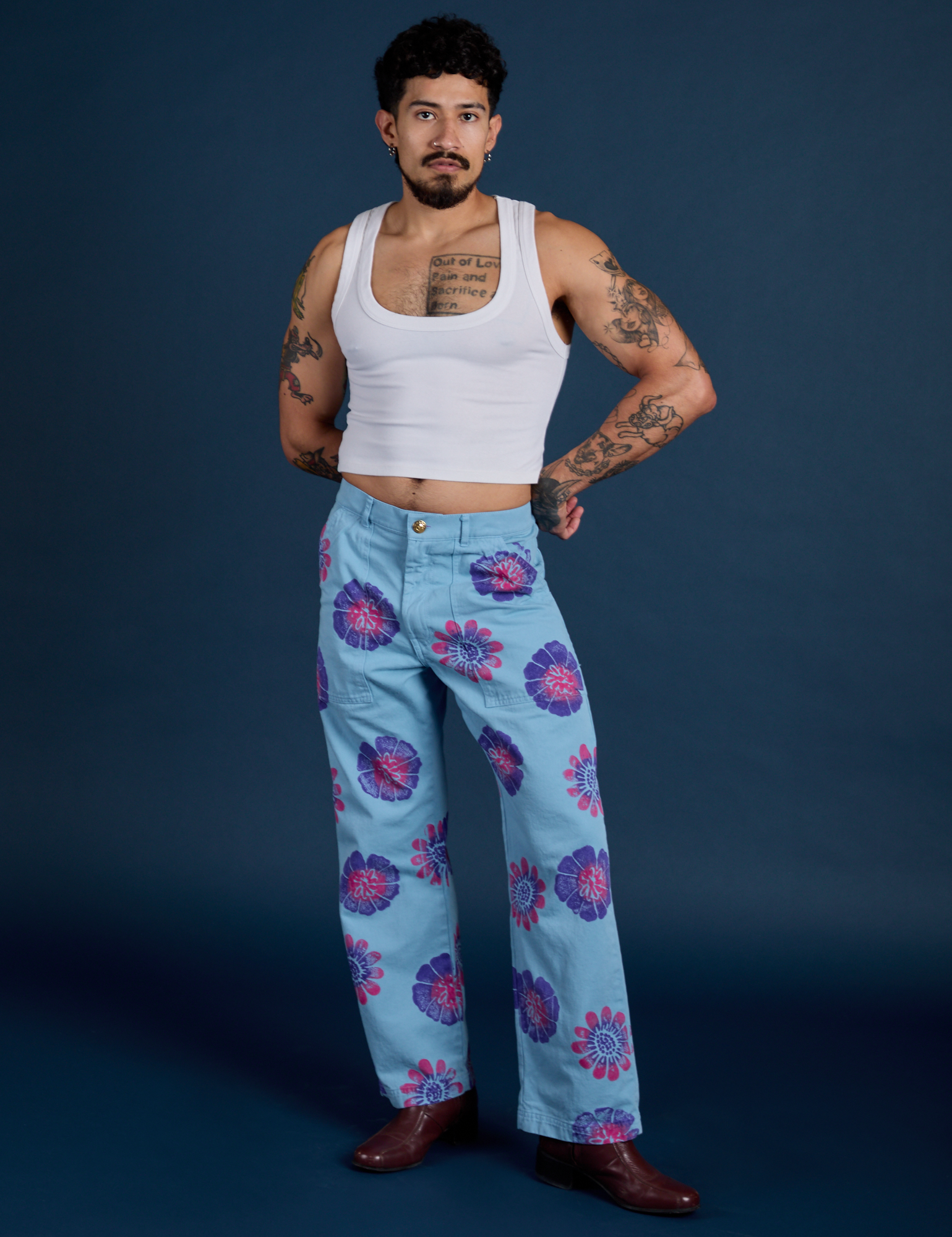 Jesse is 5’7” and wearing S Floral Painted Work Pants in Blue paired with a Cropped Tank in Vintage Tee White