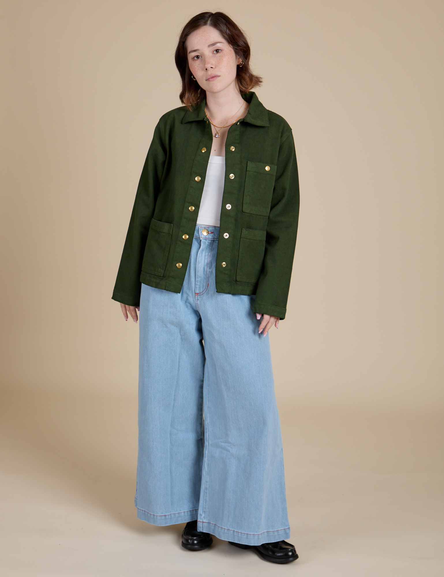Hana is wearing Denim Work Jacket in Evergreen and light wash Indigo Wide Leg Trousers